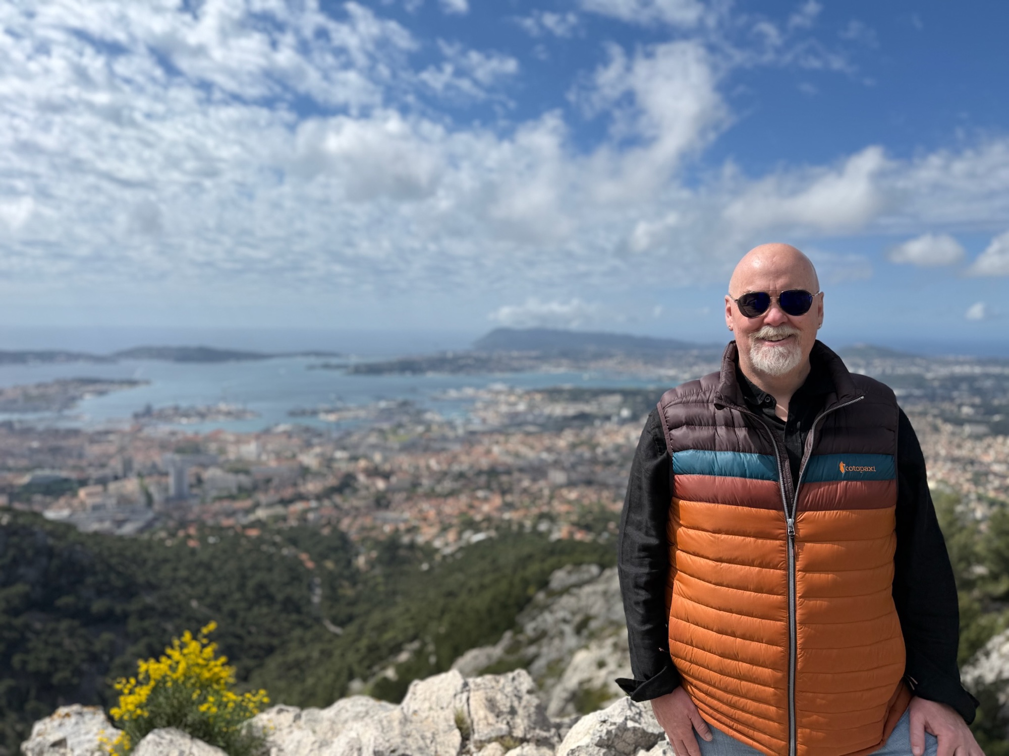 David in an orange vest overlooking Toulon from Mont Faron